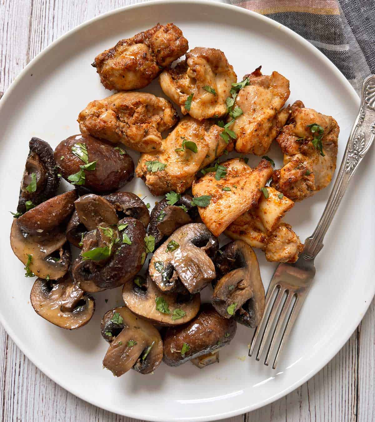 Roasted mushrooms are served with chicken.