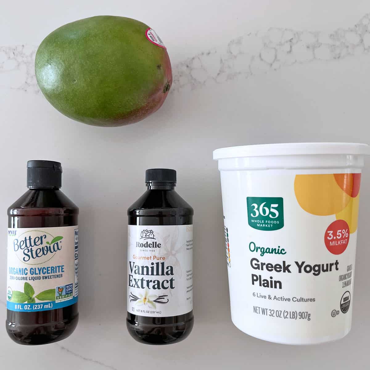 The ingredients needed to make mango frozen yogurt.