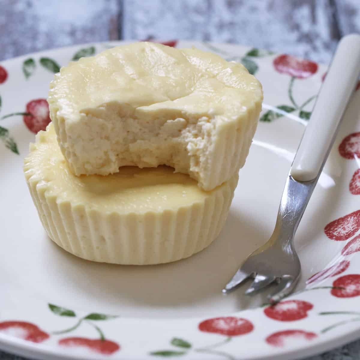 Two mini keto cheesecakes on a plate.