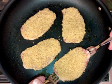 The coated pork chops were added to the skillet.