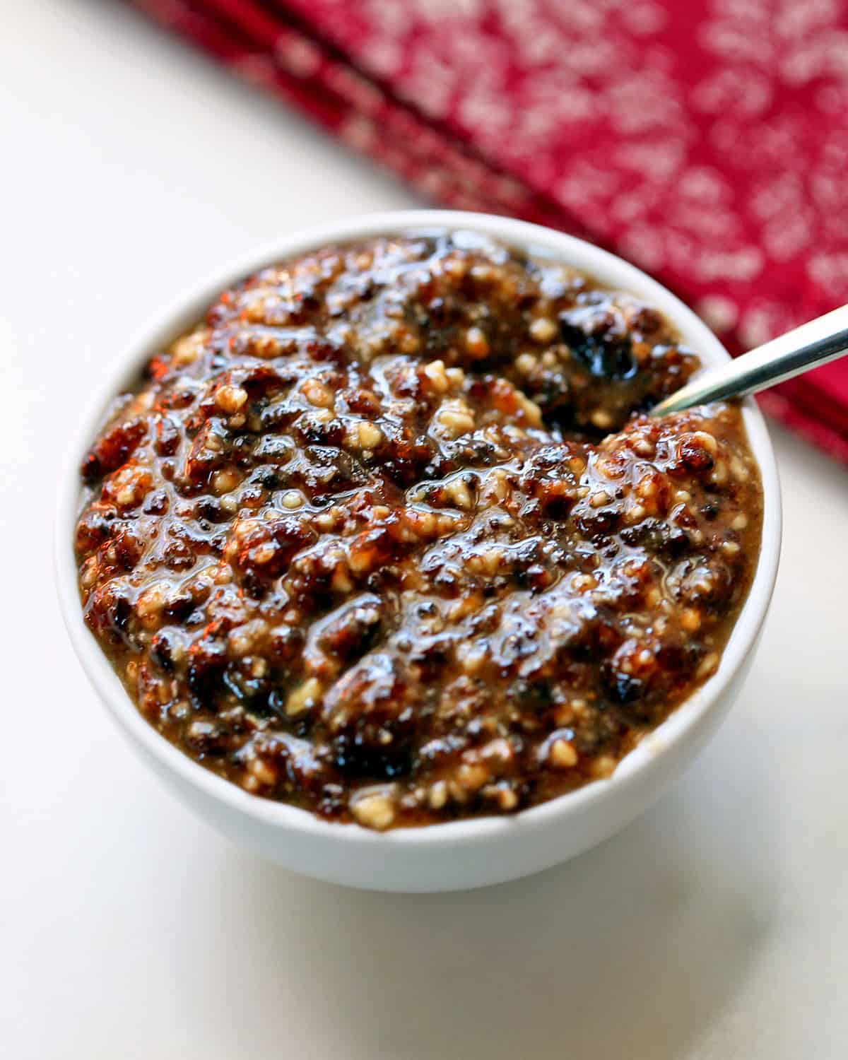 Charoset is served in a bowl with a spoon.