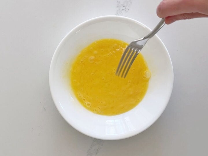 Beating an egg.