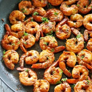 Sauteed shrimp in a skillet.