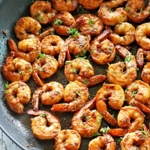 Sauteed shrimp in a skillet.