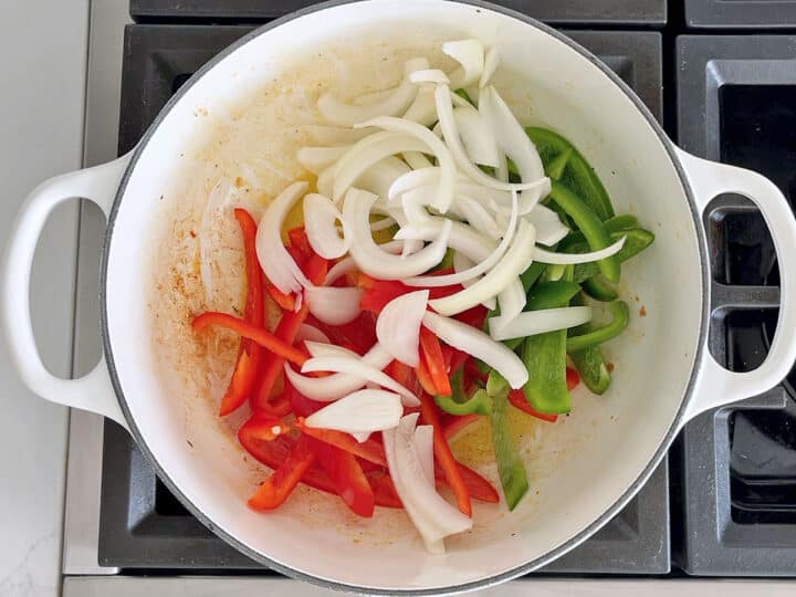 Onions and peppers were added to the saucepan.
