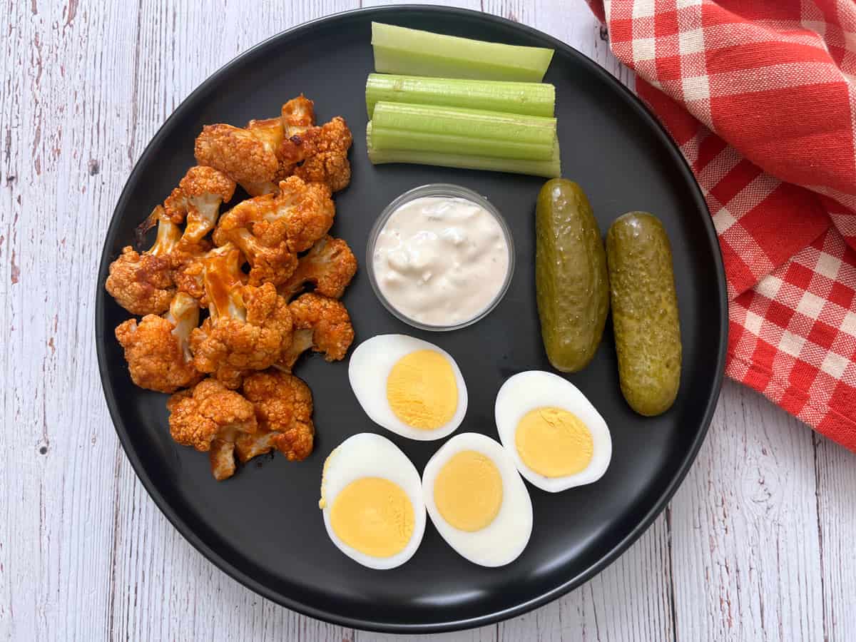 Cold buffalo cauliflower leftovers are served with hard-boiled eggs.