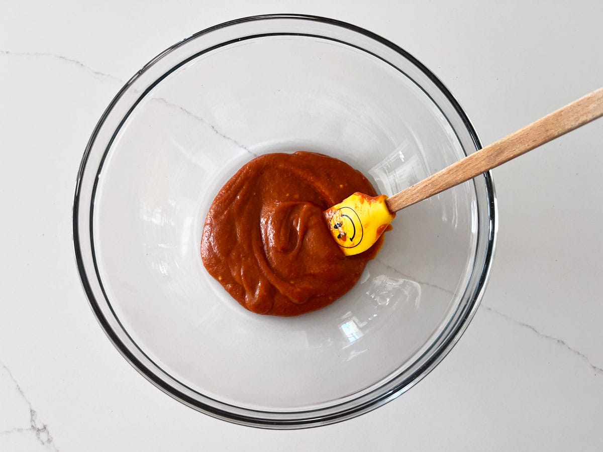 Mixing buffalo sauce in a bowl.