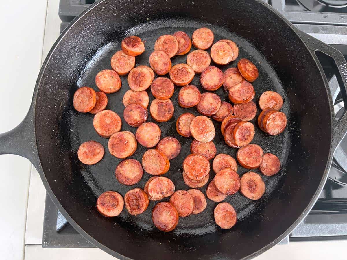 Browning the sausages in the skillet.
