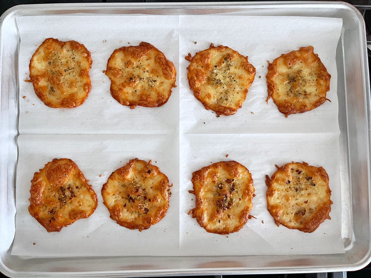 Eight cheese chips in a pan.