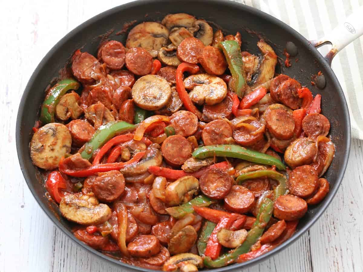 Saucy sausage and peppers in a nonstick skillet.