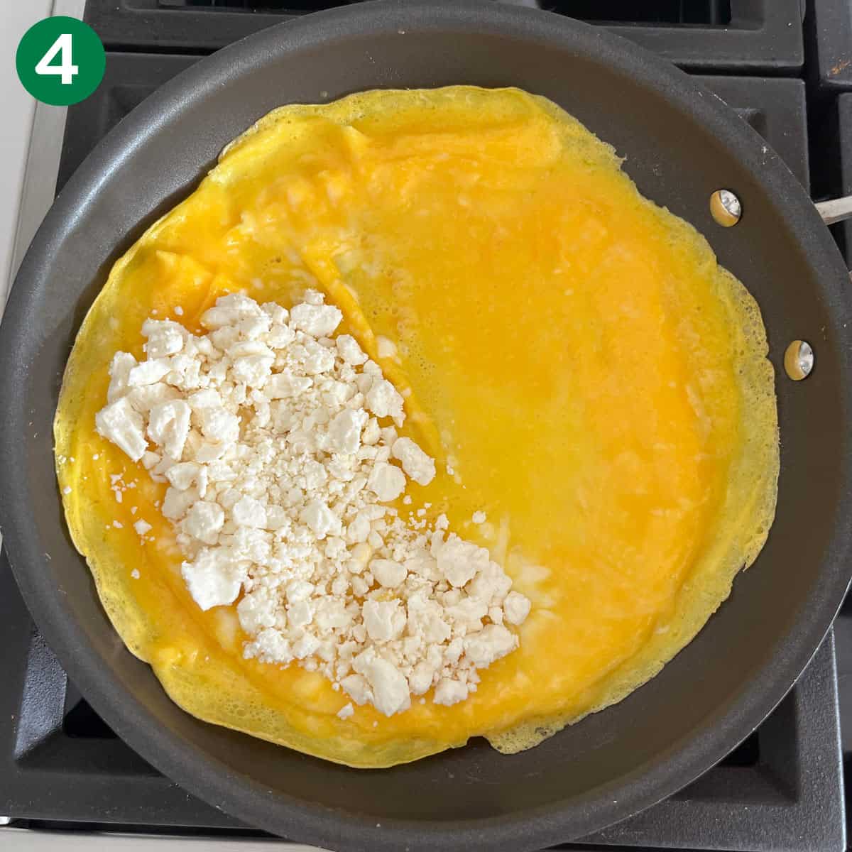 Crumbled cheese was added to half the omelette.