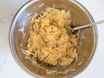 Mixing the eggs into the potatoes.