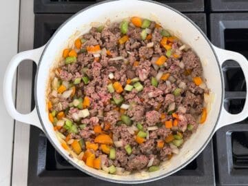 Cooking the ground beef and vegetables.