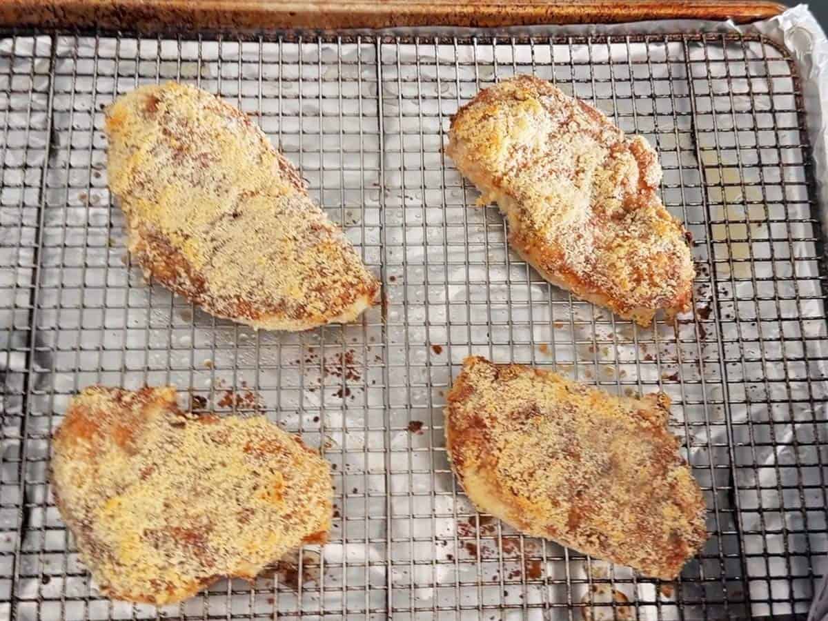 The chicken is ready on the roasting rack.