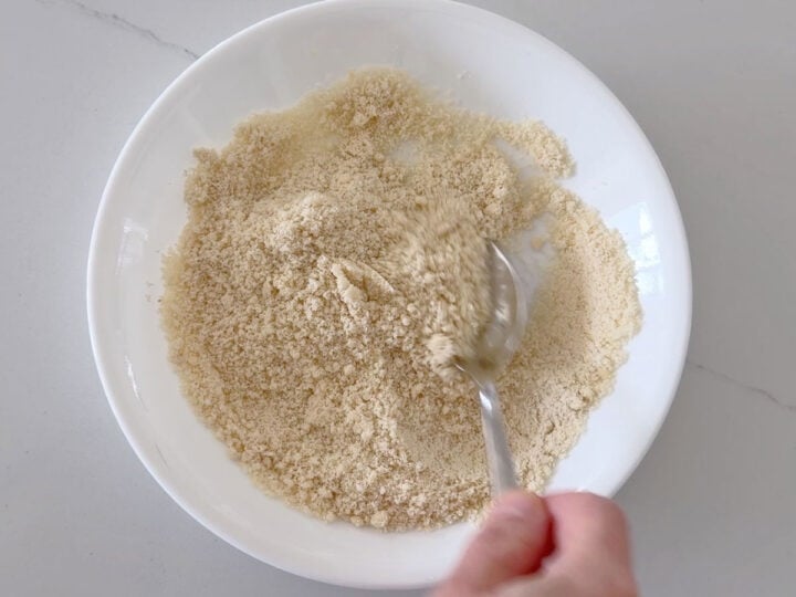 Combining almond flour and Parmesan.
