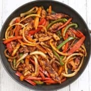 Chicken fajitas in a skillet.