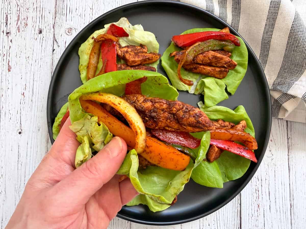 Chicken fajitas are served in lettuce wraps.
