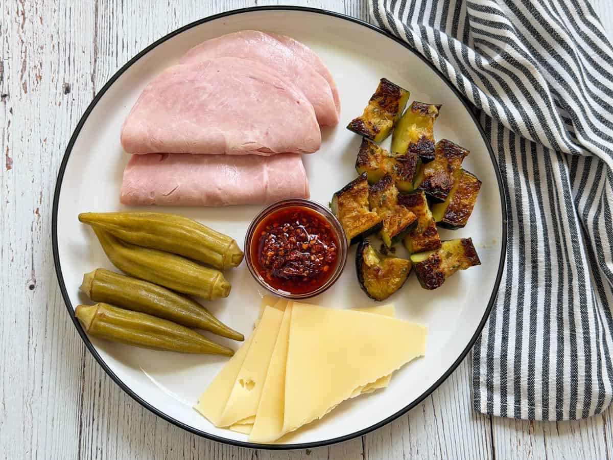 Leftover roasted zucchini is served as part of a charcuterie plate.