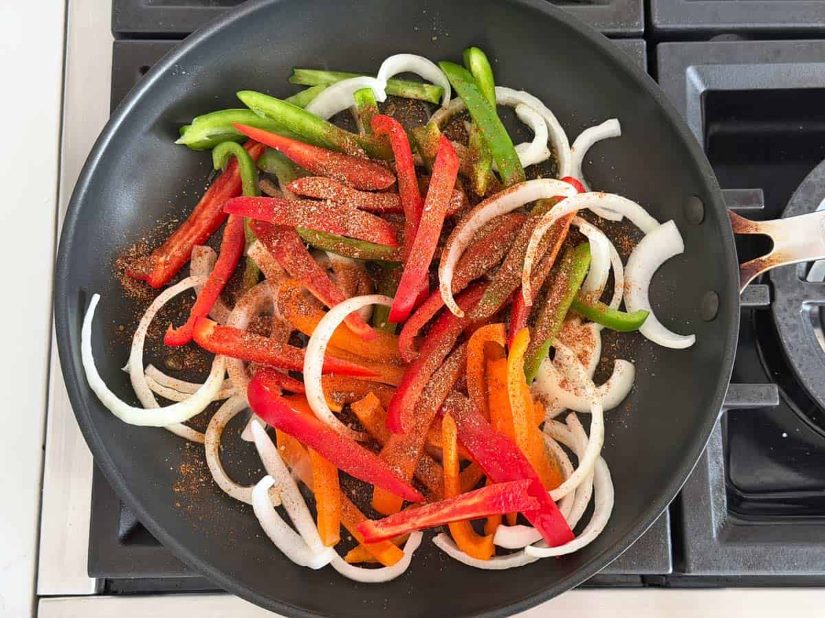 Sauteing veggies and seasonings in a skillet.