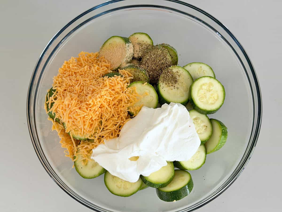 Zucchini casserole sour cream variation ingredients in a bowl.
