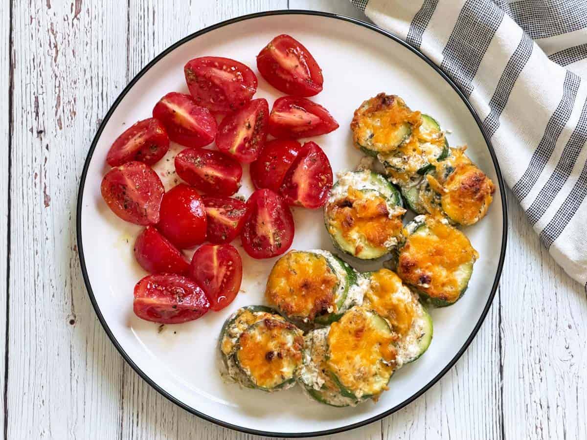Zucchini casserole leftovers are served with tomatoes.