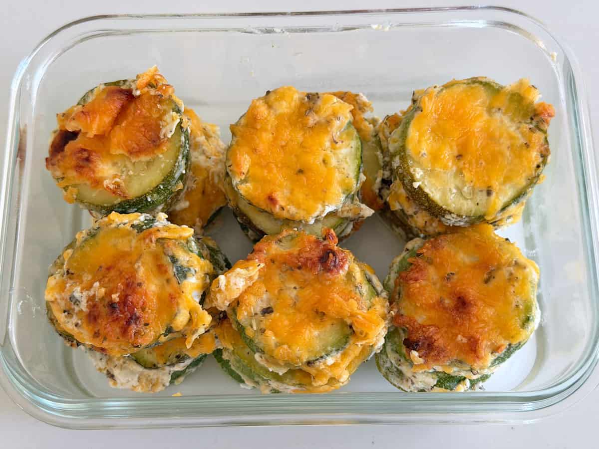 Zucchini casserole leftovers are stored in a glass container.