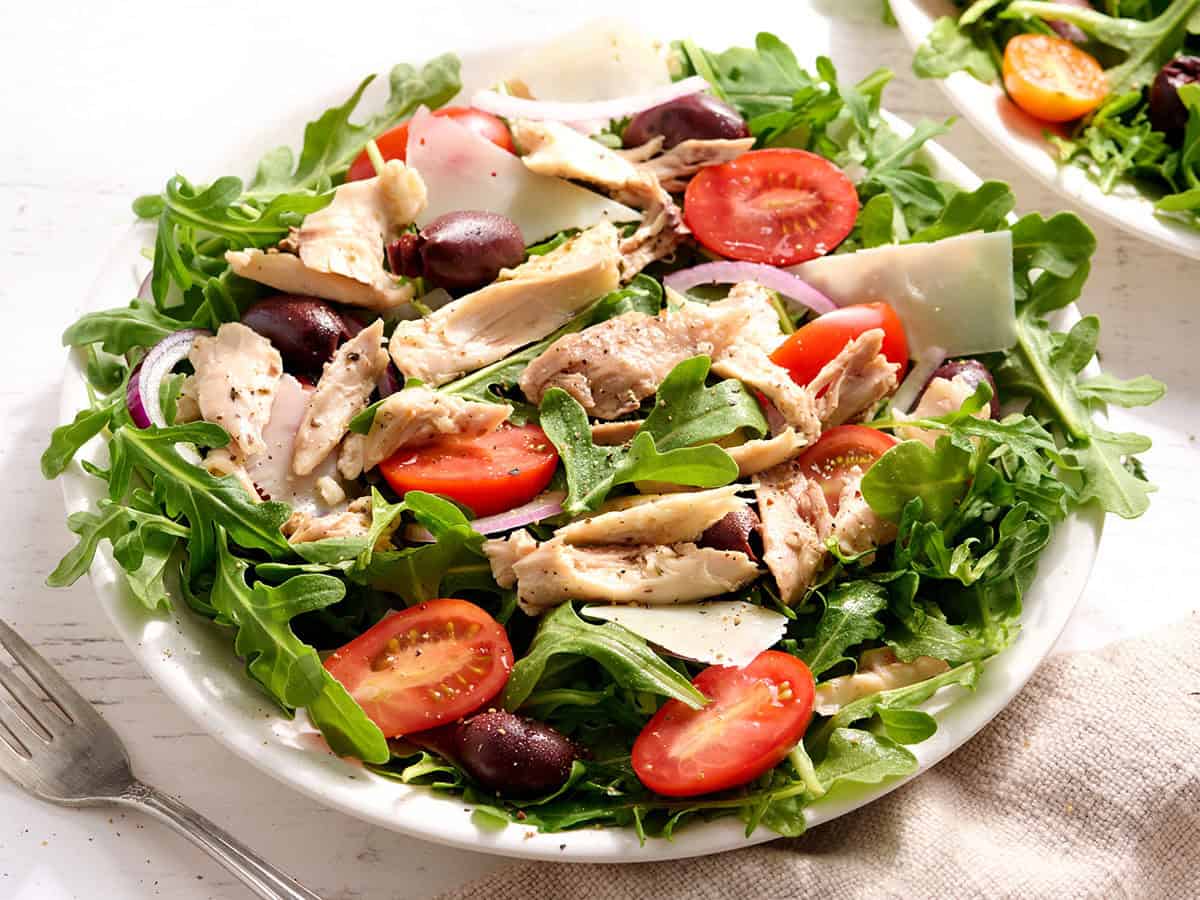 Sheet pan chicken leftovers are served in a salad.