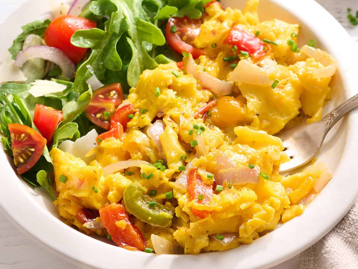 Scrambled eggs wth leftover veggies and a side salad.