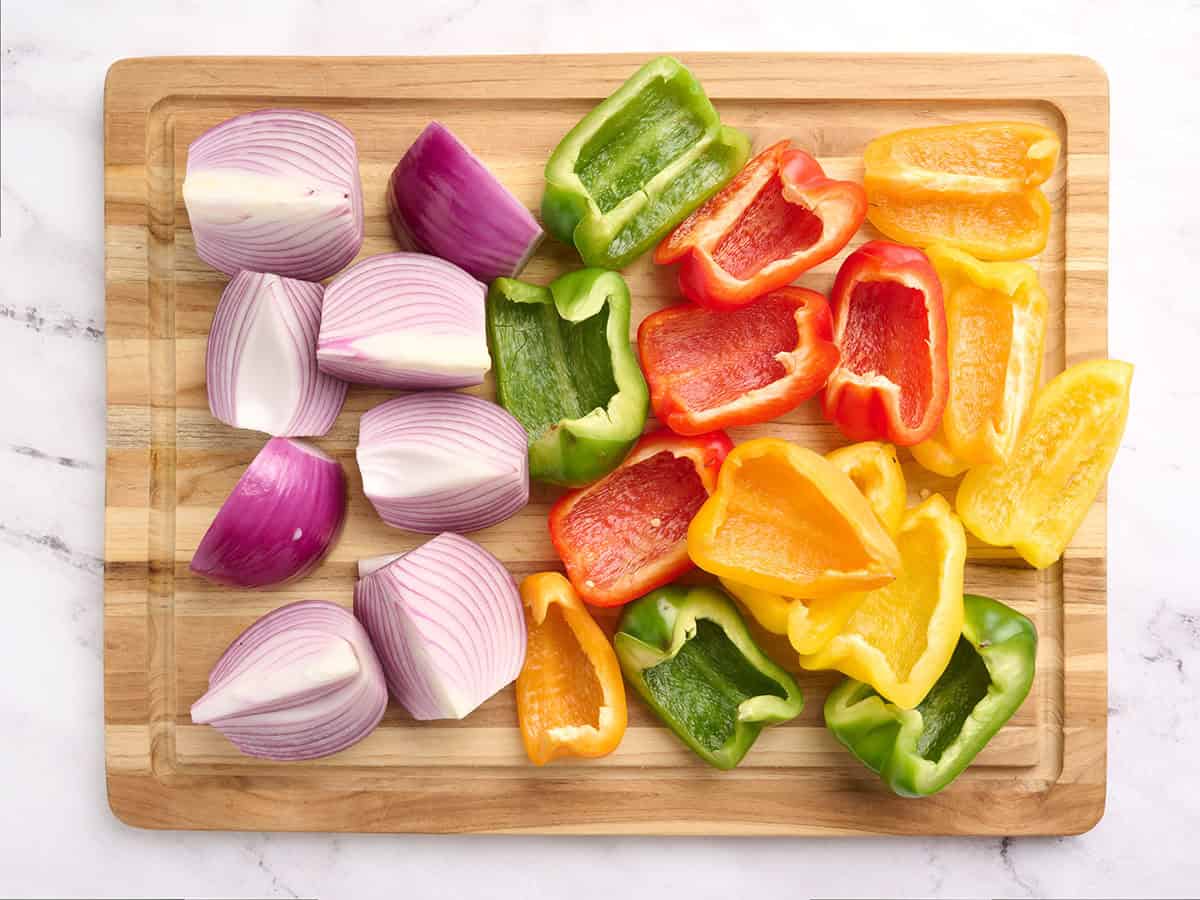 Quartered vegetables on a cutting board.