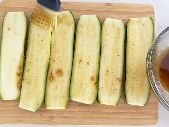 Brushing the zucchini with the marinade.