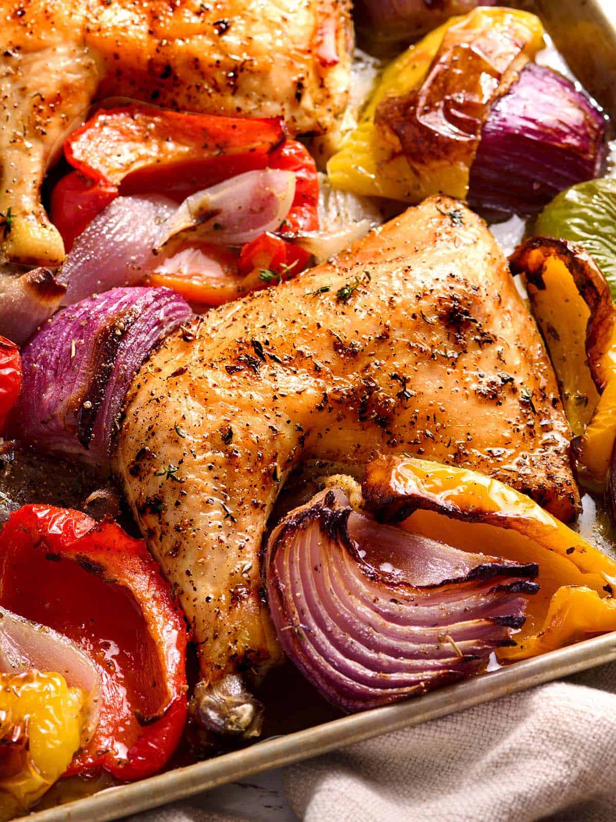 Sheet pan chicken and vegetables on a baking sheet.