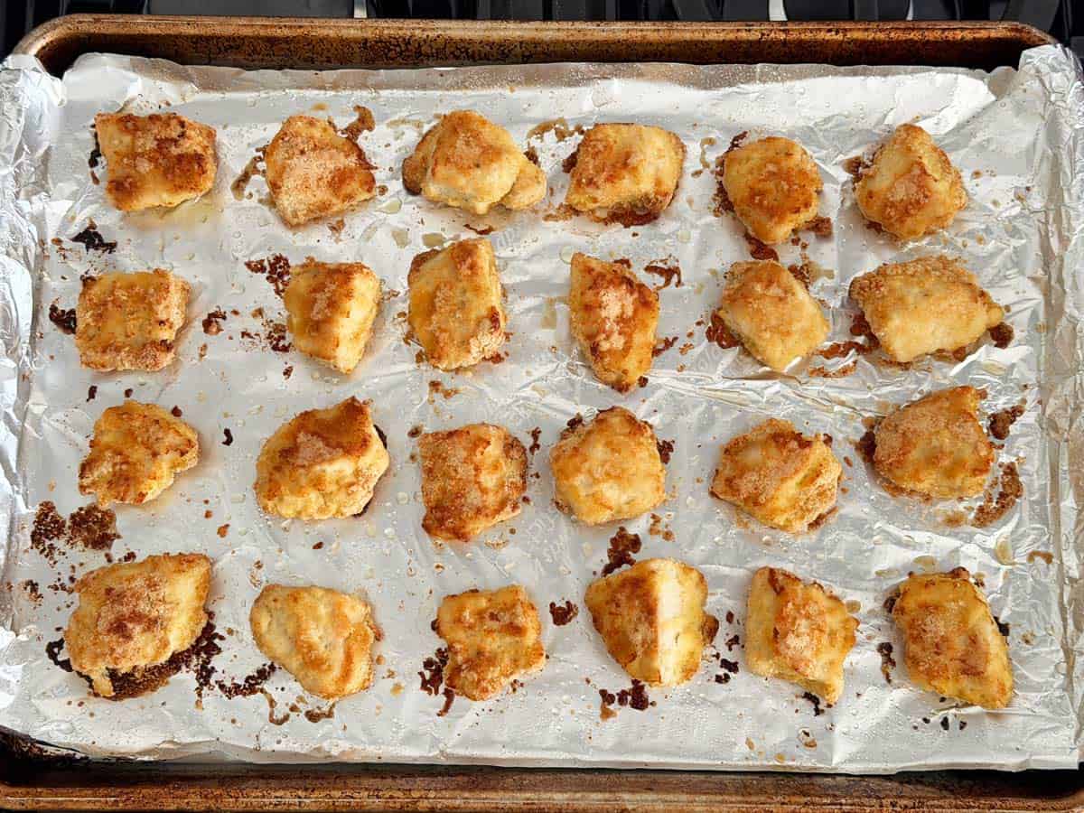 Keto chicken nuggets in a pan after broiling.