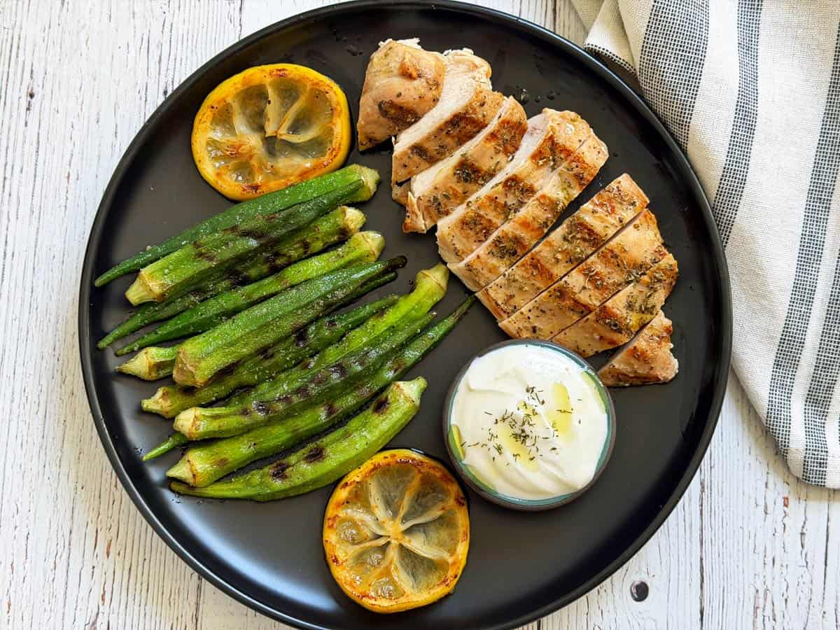 Grilled okra is served with Greek chicken.