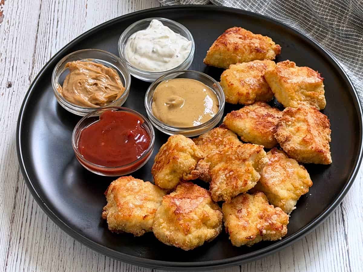 Keto chicken nuggets are served with a variety of dips.