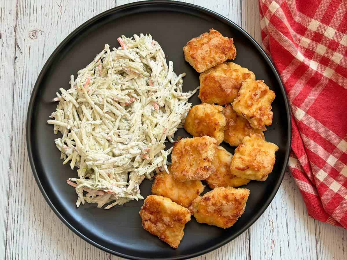 Keto chicken nuggets are served with coleslaw.