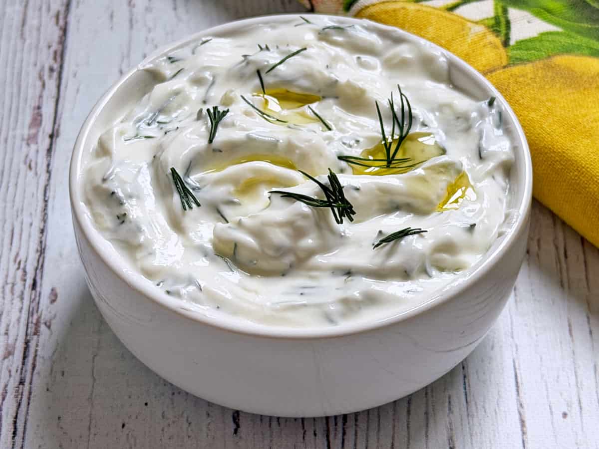Tzatziki sauce is served in a bowl.